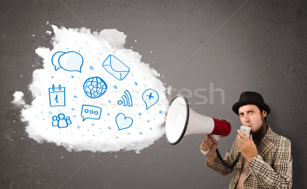 Man shouting into loudspeaker and modern blue icons and symbols  Stock photo © ra2studio