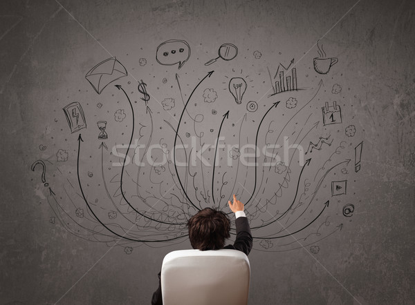 Businessman in front of a chalkboard deciding with arrows and si Stock photo © ra2studio