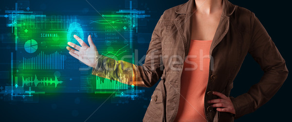 Young businesswoman pressing modern technology panel with finger Stock photo © ra2studio