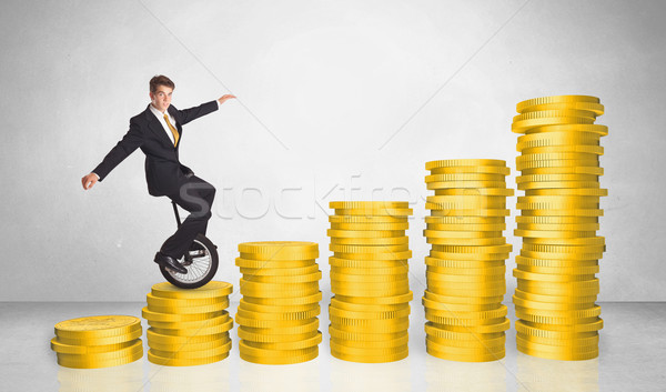 Business man riding monocycle up on coin graph Stock photo © ra2studio