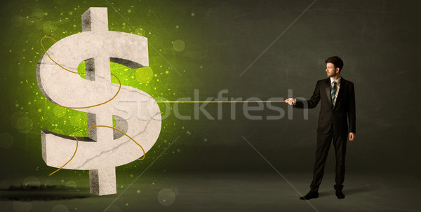 Business man pulling a big green dollar sign Stock photo © ra2studio