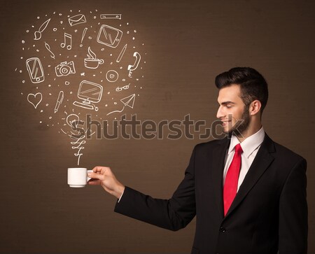 Businessman holding a white cup with social media icons Stock photo © ra2studio