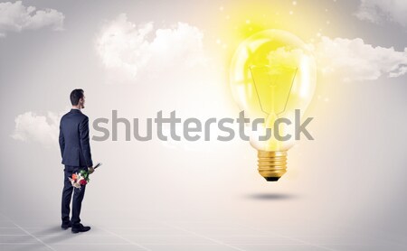 Businessman on rock mountain with idea bulb Stock photo © ra2studio