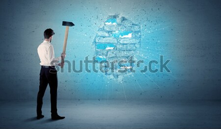 Business man hitting brick wall with huge hammer Stock photo © ra2studio