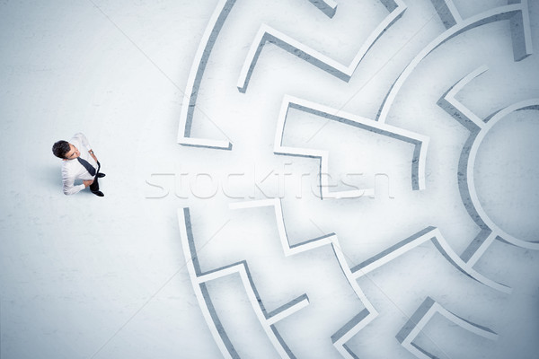 Business man looking at circular maze with nowhere to go Stock photo © ra2studio