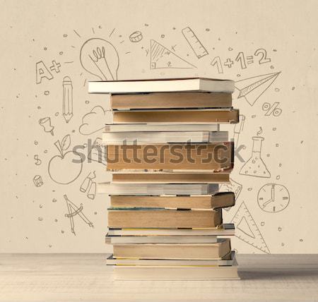 A pile of books on table with school hand drawn doodle sketches Stock photo © ra2studio