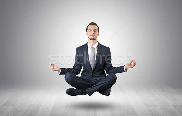 Businessman meditates in an empty space concept Stock photo © ra2studio