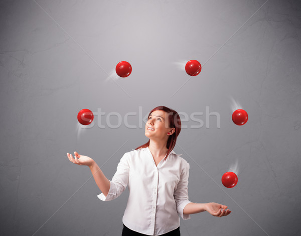 young girl standing and juggling with red balls Stock photo © ra2studio