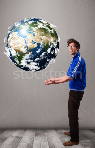 Good-looking man holding 3d planet earth Stock photo © ra2studio