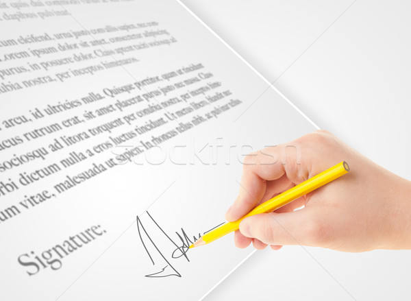 Stock photo: Hand writing personal signature on a paper form