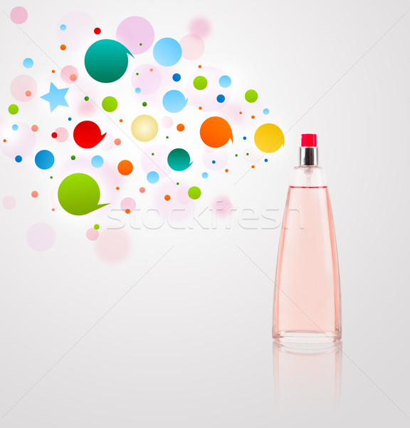 Stock photo: Perfume bottle spraying colored bubbles