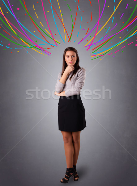 Young girl thinking with colorful abstract lines overhead Stock photo © ra2studio