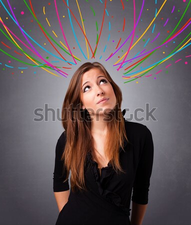 Young girl thinking with colorful abstract lines overhead Stock photo © ra2studio