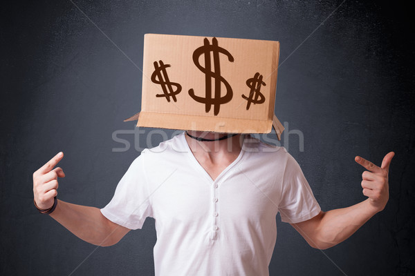 Young man gesturing with a cardboard box on his head with dollar Stock photo © ra2studio