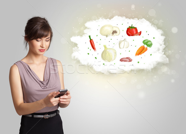 Pretty woman presenting a cloud of healthy nutritional vegetable Stock photo © ra2studio