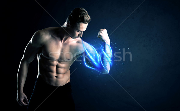 Fit athlete lifting weight with blue muscle light concept Stock photo © ra2studio