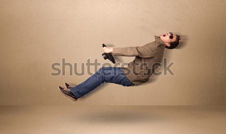 Happy funny man driving a flying car concept Stock photo © ra2studio