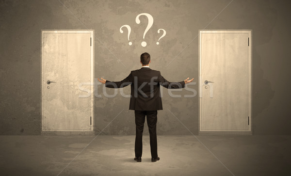 Businessman standing in front of doors Stock photo © ra2studio