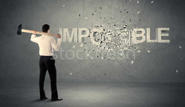 Business man hitting impossible sign with hammer Stock photo © ra2studio