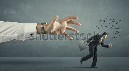 Empresário corrida longe grande mão pontos de interrogação Foto stock © ra2studio