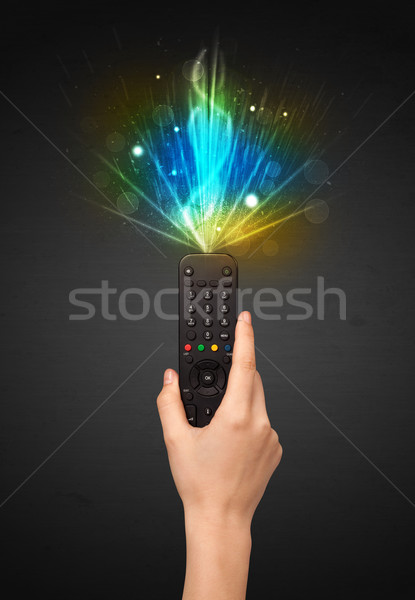 Hand with remote control and explosive signal Stock photo © ra2studio