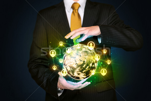 Businessman holding a social media globe Stock photo © ra2studio