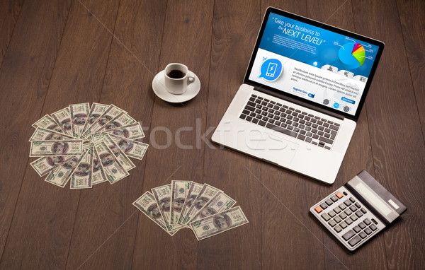 Laptop on office desk with business website on screen Stock photo © ra2studio