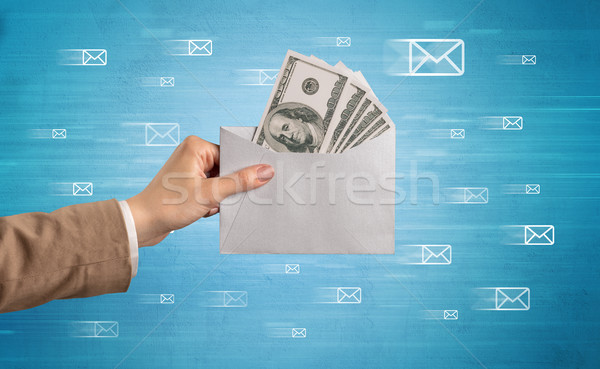Stock photo: Hand holding envelope with message symbols around