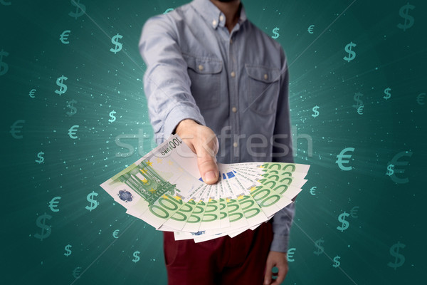 Geschäftsmann halten Geld jungen groß Betrag Stock foto © ra2studio