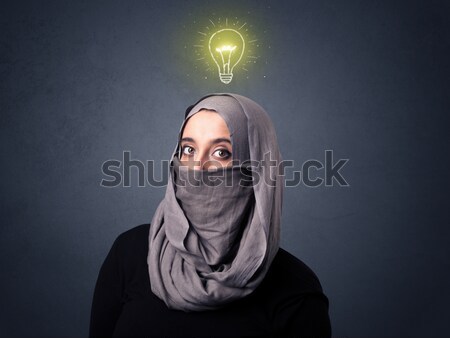 Muzułmanin kobieta młodych żarówka powyżej Zdjęcia stock © ra2studio