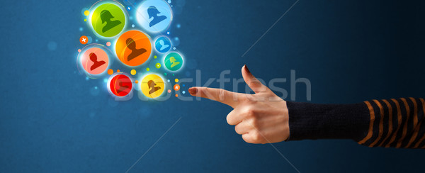 Social media icons coming out of gun shaped hand Stock photo © ra2studio