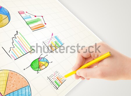 Business person drawing colorful graphs and icons on paper Stock photo © ra2studio