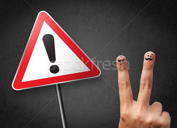 Stock photo: Happy cheerful smiley fingers looking at triangle warning sign with exclamation mark