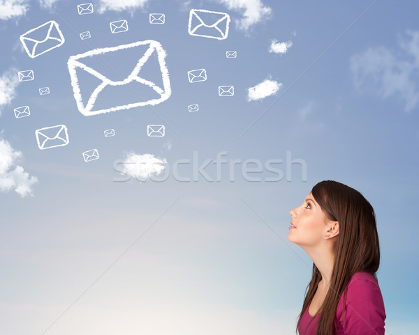 Młoda dziewczyna patrząc mail symbol chmury Błękitne niebo Zdjęcia stock © ra2studio