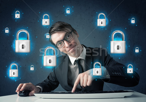 Young hacker with virtual lock symbols and icons Stock photo © ra2studio