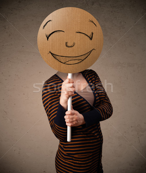 Young woman holding a smiley face board Stock photo © ra2studio