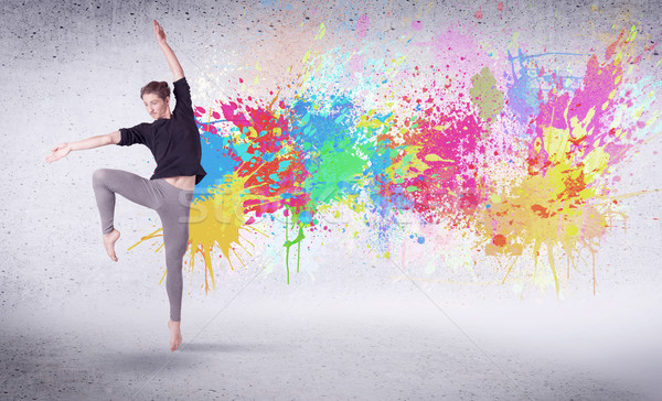 Modern street dancer jumping with colorful paint splashes Stock photo © ra2studio