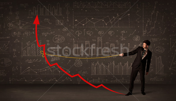 Businessman pulling a red arrow upright with a rope  Stock photo © ra2studio