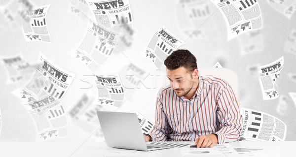 Business man at desk with stock market newspapers Stock photo © ra2studio