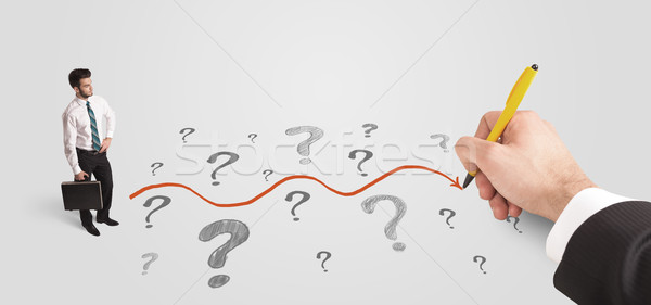 Stock photo: Business man looking at question marks and solution path
