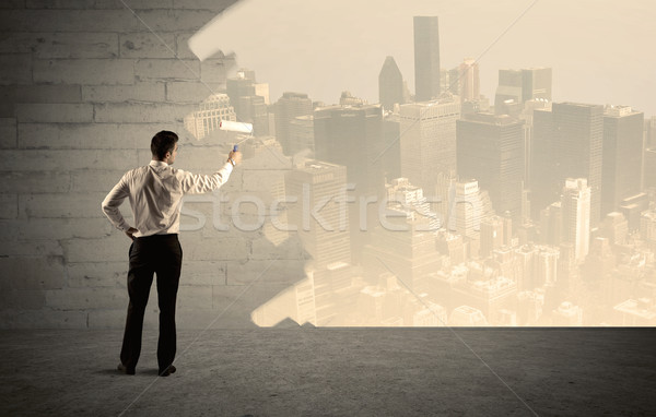 Salesman painting city scape on wall Stock photo © ra2studio