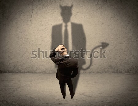 Salesman facing his own devil shadow Stock photo © ra2studio