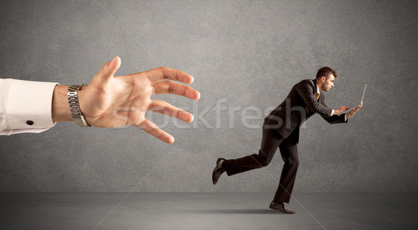 Businessman running from hand Stock photo © ra2studio