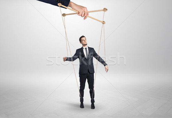 Stock photo: Puppet businessman leaded by a huge hand
