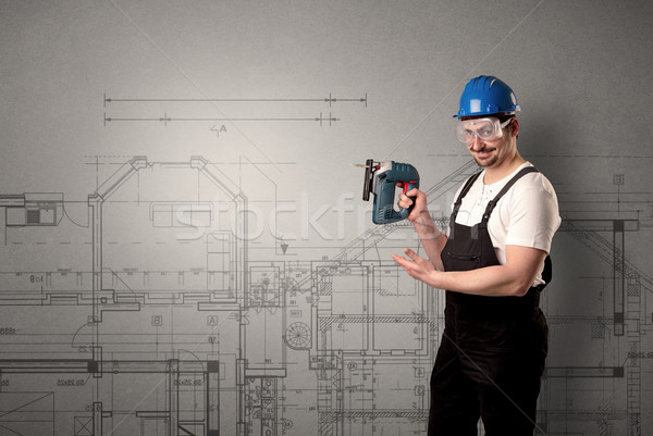 Worker with technical drawing. Stock photo © ra2studio