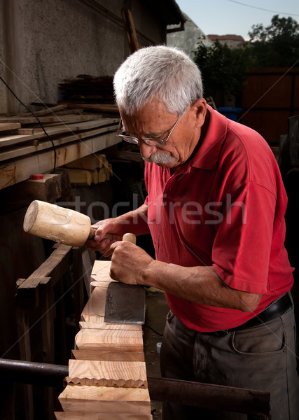 Stock photo: woodcarver working with mallet and chisel