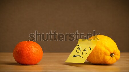 Lemon with post-it note sticking out tongue to orange Stock photo © ra2studio