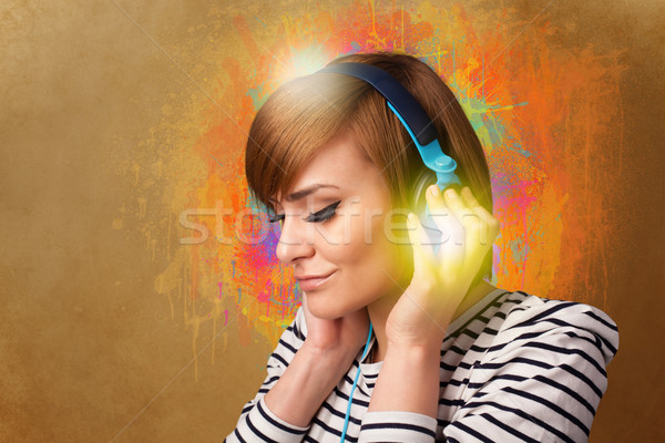Young woman with headphones listening to music Stock photo © ra2studio