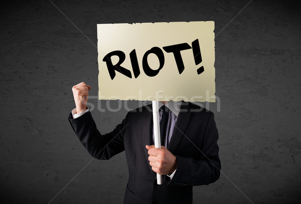 Stock photo: Businessman holding a protest sign