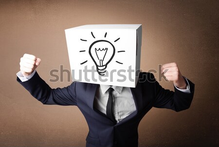 Businessman gesturing with a cardboard box on his head with ligh Stock photo © ra2studio
